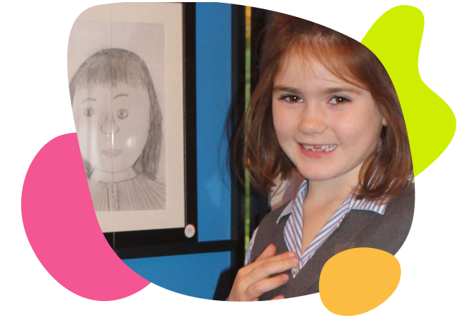 Girl smiling in front of artwork